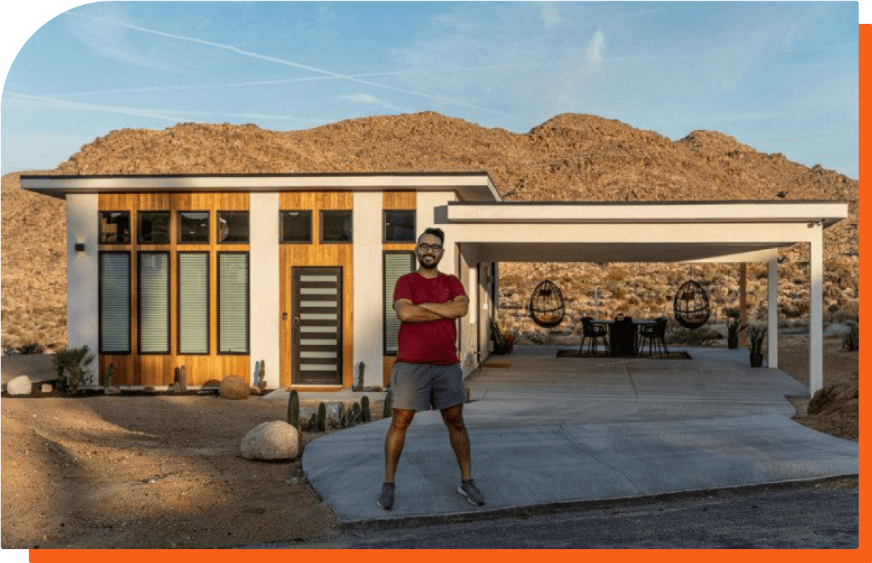Image of Robert Abasolo standing in front of the Butterfly House in Joshua Tree, California